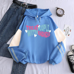 Light blue graphic hoodie with message 'Treat People With Kindness' featuring colorful letters and heart designs